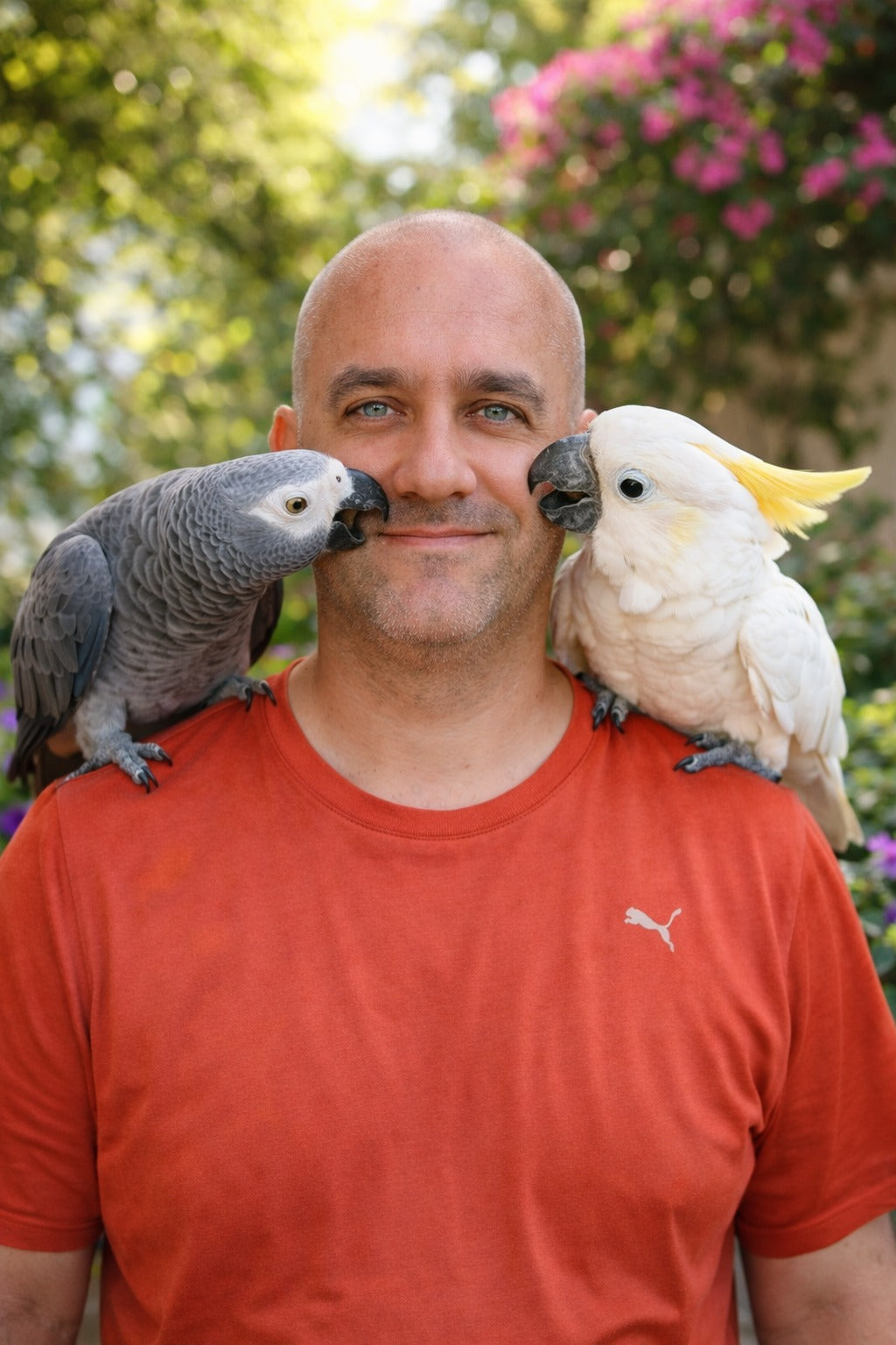 Allan sitting with a parrot a cockatoo