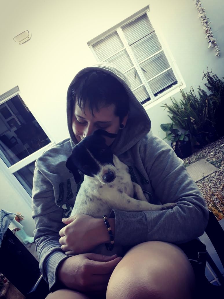 Danielle sitter hugging a Jack Russell doggie